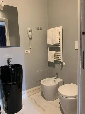 a bathroom with a toilet and a sink at Rhome Luxury suite in Rome