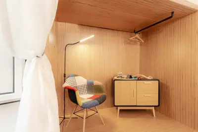 a room with a chair and a desk and a lamp at Casa Frisi in Rome