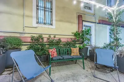 two chairs and a bench in front of a building at Casa Frisi in Rome