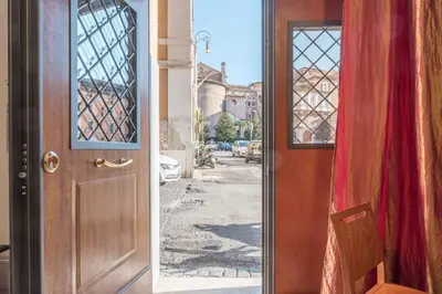 an open door with a view of a street at GuestHost - Monti Artistic Flat in Rome