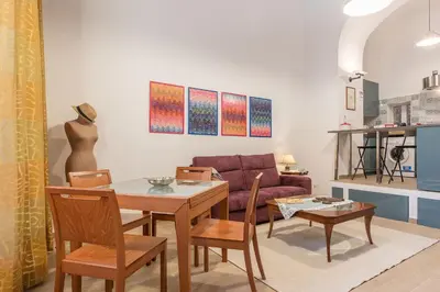 a living room with a table and a couch at GuestHost - Monti Artistic Flat in Rome