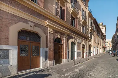 a brick building with a large wooden door on a street at GuestHost - Monti Artistic Flat in Rome