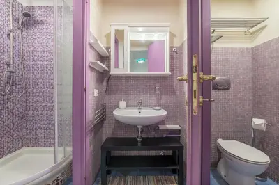 a bathroom with a sink and a toilet at GuestHost - Monti Artistic Flat in Rome