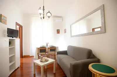 a living room with a couch and a table at MECENATE DELUXE COLOSSEUM in Rome