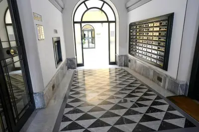 a hallway with a black and white checkered floor at MECENATE DELUXE COLOSSEUM in Rome