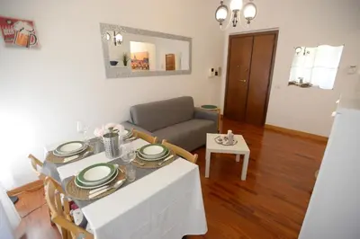 a living room with a table and a couch at MECENATE DELUXE COLOSSEUM in Rome