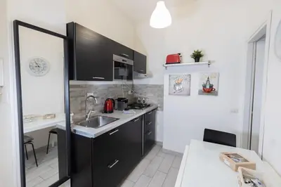a small kitchen with a sink and a counter at Nicla's Home in Rome
