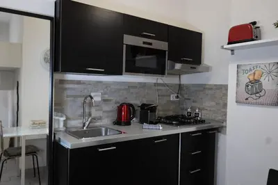 a kitchen with a sink and a microwave at Nicla's Home in Rome