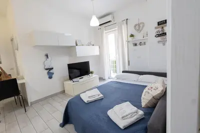a bedroom with a blue bed with towels on it at Nicla's Home in Rome