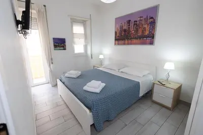 a bedroom with a bed with two towels on it at Nicla's Home in Rome
