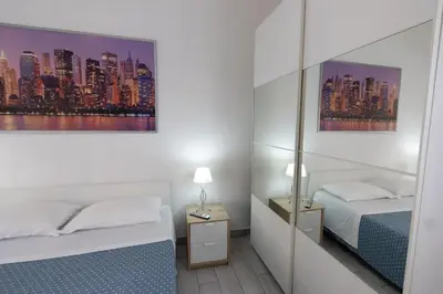 a bedroom with two beds and a city skyline at Nicla's Home in Rome
