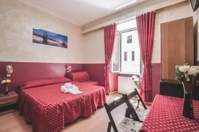 a bedroom with a red bed and a table and chairs at Vertex Homes in Rome