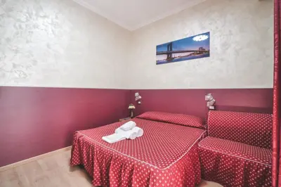 a room with two beds with red sheets at Vertex Homes in Rome