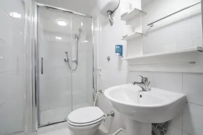 a bathroom with a toilet and a sink and a shower at Vertex Homes in Rome