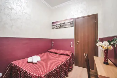 a bedroom with a red bed with white towels on it at Vertex Homes in Rome