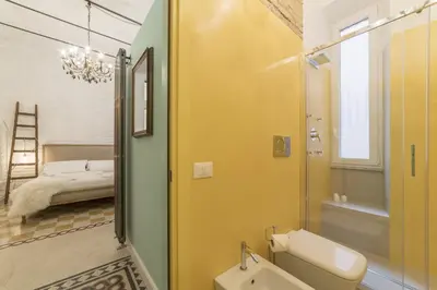 a bathroom with a tub and a sink and a mirror at Romantic Vintage Colosseum Suite in Rome