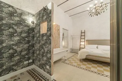 a bathroom with a bath tub and a bed in it at Romantic Vintage Colosseum Suite in Rome