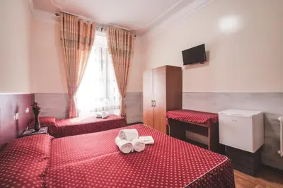 a hotel room with two beds with red sheets at Vertex Guest House in Rome