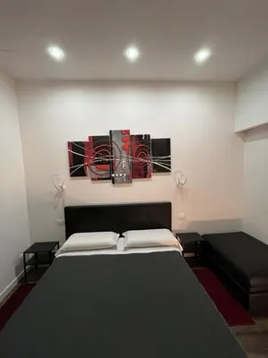 a bedroom with a bed and a painting on the wall at Domus Flavia B&B in Rome
