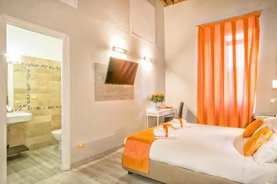 a hotel room with a bed and a bathroom at History Suite in Rome