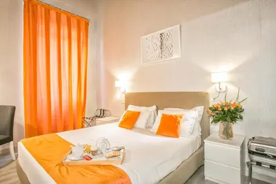 a hotel room with a bed with a tray of food on it at History Suite in Rome