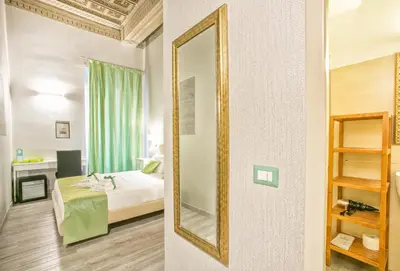 a bedroom with a bed and a mirror at History Suite in Rome