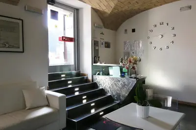 a waiting room with benches and a clock on the wall at Residenza Adriana in Rome