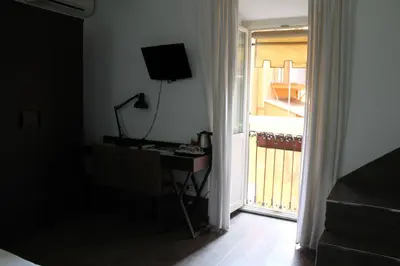 a room with a desk and a door to a balcony at Relais Palazzo Taverna in Rome
