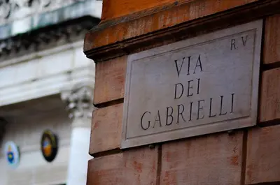 a sign on the side of a brick building at Relais Palazzo Taverna in Rome