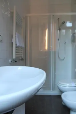 a bathroom with a white sink and a shower at Relais Palazzo Taverna in Rome