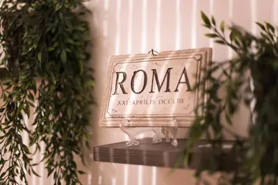 a sign that says roma next to some plants at Quelli della via Gluck in Rome