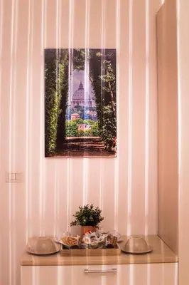 a table with a picture and a plant on it at Quelli della via Gluck in Rome