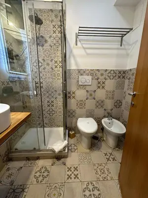 a bathroom with a shower and a toilet and a sink at Double B in Rome