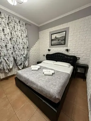 a bedroom with a bed with two towels on it at Double B in Rome
