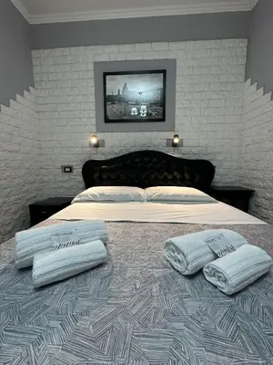 a bedroom with a bed with two towels on it at Double B in Rome