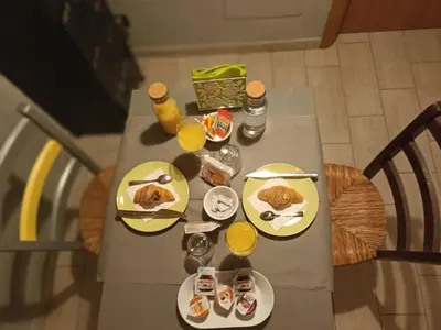 a table with plates of food and glasses of orange juice at Double B in Rome