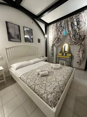 a bedroom with a large bed with two towels on it at Double B in Rome