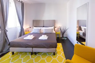 a bedroom with a bed with two towels on it at Rent in Rome - IV Novembre in Rome