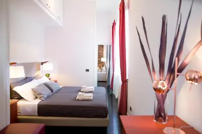 a bedroom with a bed and a vase on a table at Rent in Rome - IV Novembre in Rome