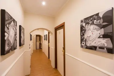 a hallway with paintings on the walls at Filomena Arthouse in Rome
