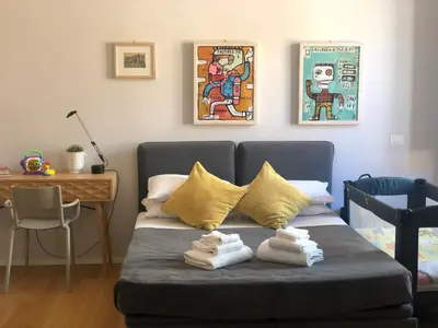 a bed with towels on it in a room at Belsiana Luxury Apartment in Rome