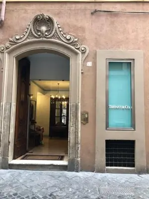an entrance to a building with an arch doorway at Belsiana Luxury Apartment in Rome