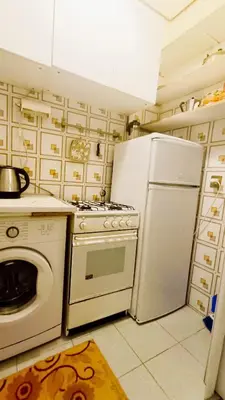 a kitchen with a stove and a refrigerator at Lovely 5 min walk to Saint Peter Basilica in Rome