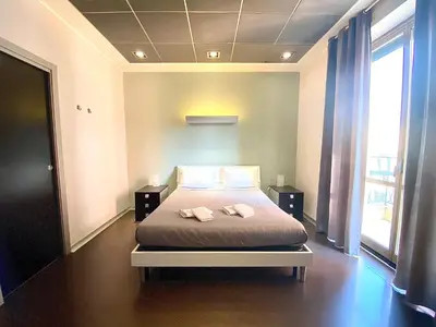 a bedroom with a bed with two towels on it at Gemini Guest House in Rome