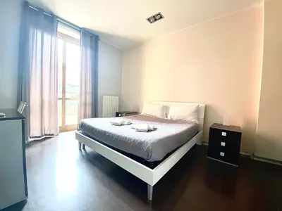 a bedroom with a bed and a large window at Gemini Guest House in Rome