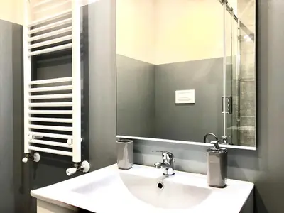 a bathroom with a white sink and a mirror at Gemini Guest House in Rome