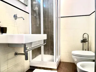 a bathroom with a shower and a sink and a toilet at Gemini Guest House in Rome