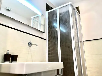 a bathroom with a sink and a shower at Gemini Guest House in Rome