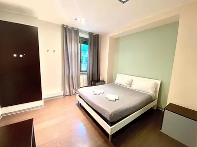a bedroom with a bed with two candles on it at Gemini Guest House in Rome