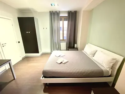 a bedroom with a bed with two towels on it at Gemini Guest House in Rome